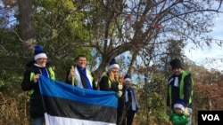 Team Estonia, which participated in the EU representatives' tree-planting effort in Washington, was led by Ambassador Jonatan Vseviov, second from left, and featured Johannas, age 2½, son of Ranner Selge, IT specialist at the embassy. (Natalie Liu/VOA) 