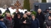 Lyudmila Navalnaya (C) and Anatoly Navalny (2nd L), parents of late Russian opposition leader Alexei Navalny, mourn next to a coffin during a funeral ceremony for his son at the Borisovo cemetery in Moscow's district of Maryino on March 1, 2024.