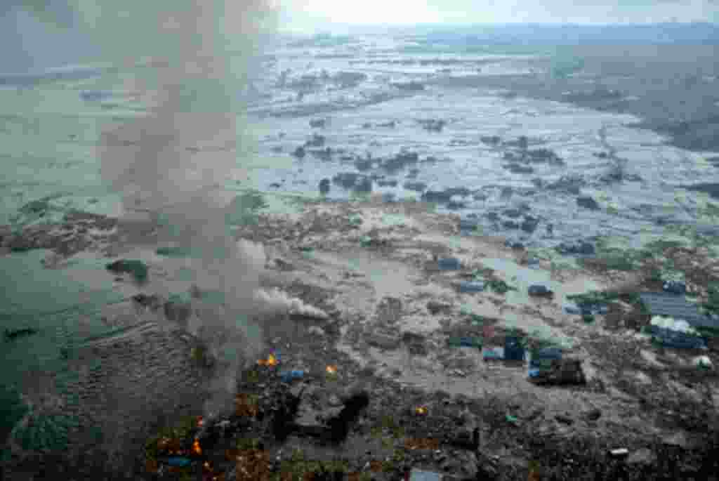 Fires burn in a harbor following an earthquake and tsunami in Natori City, Miyagi Prefecture, northeastern Japan, March 11, 2011