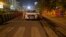 An Indian police, left, and a paramilitary personnel stop a vehicle during a complete lockdown amid growing concerns of coronavirus in Gauhati, India, March 24, 2020.