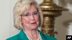 FILE - Lilly Ledbetter looks to the audience as President Barack Obama speaks in the East Room of the White House in Washington, April 8, 2014, during an event marking Equal Pay Day. 