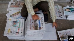FILE - A Bangladeshi worker sorts newspapers, in Dhaka, Bangladesh, Feb. 20, 2016. Under Section 57 of Bangladesh’s Information and Communications Technology Act, journalists can be jailed for offenses such as defamation or hurting religious sentiment.