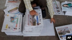 FILE - A Bangladeshi worker classifies newspapers, in Dhaka, Bangladesh, Feb. 20, 2016. Under Section 57 of Bangladesh’s Information and Communications Technology Act, journalists can be jailed for a variety of offenses, such as defamation, hurting religious sentiment, and tarnishing the image of the state or an individual. 