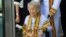 Kimlan Jinakul, 91, attends her graduation ceremony at Sukhothai Thammathirat Open University where she received a bachelor's degree from Thailand's King Maha Vajiralongkorn Bodindradebayavarangkun, near Bangkok, Aug. 9, 2017.