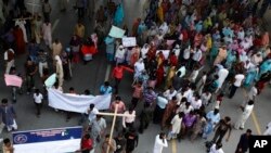 Pakistani Christians block a main highway during a rally to condemn a suicide bombing on a church, in Islamabad, Pakistan, Sept. 23, 2013. 