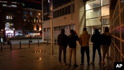 Unaccompanied minors from Morocco seeking shelter, stand outside a police station in Barcelona, Spain, Nov. 9, 2018. 