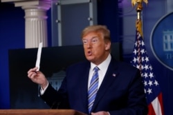 U.S. President Donald Trump shows a packaging containing a swab to be used for coronavirus disease (COVID-19) testing during the daily coronavirus task force briefing at the White House in Washington, U.S., April 19, 2020.