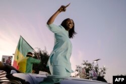 FILE—Presidential candidate and founder of the Alternative pour la relève citoyenne (ARC) party, Anta Babacar Ngom waves to supporters in the Hann Mariste district of Dakar on March 11, 2024.