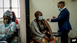 A woman is vaccinated against COVID-19 at the Hillbrow Clinic in Johannesburg, South Africa, Dec. 6, 2021.