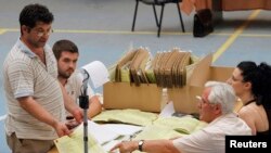 Albanian election officials count votes in Tirana, June 24, 2013.