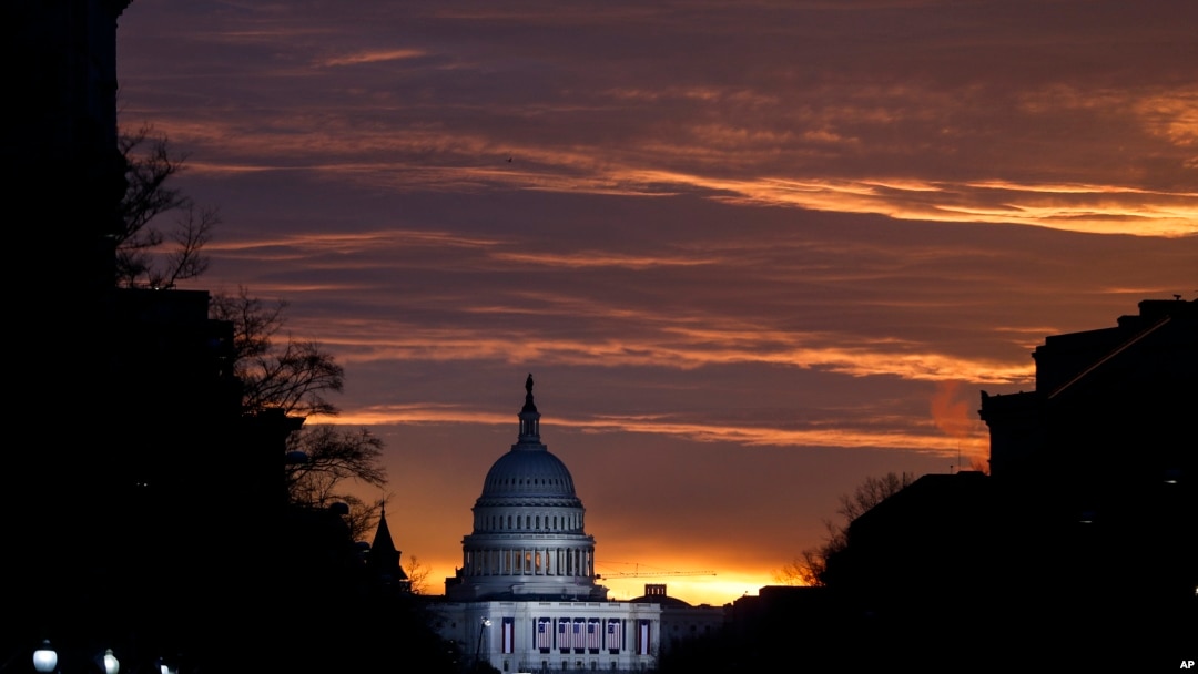 FILE - The U.S. Capitol Building is illuminated during sunrise in Washington.