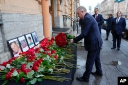 St. Petersburg Governor Alexander Beglov lays a bunch of flowers at the Consulate of Azerbaijan in the memory of victims of the Azerbaijan Airlines' Embraer 190 that crashed near the Kazakhstan's airport of Aktau, in St. Petersburg, Russia, Dec. 26, 2024.