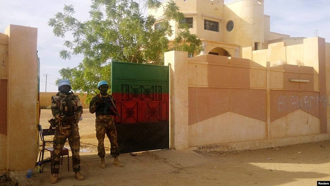 FILE - MINUSMA peacekeepers stand guard in front of the governor's office in Kidal, Mali.