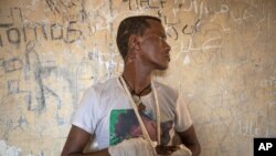 File-Ethnic Tigrayan survivor Abrahaley Minasbo, 22, from Mai-Kadra, Ethiopia, shows his wounds from machetes, inside a shelter, in Hamdeyat Transition Center near the Sudan-Ethiopia border, eastern Sudan, Dec. 15, 2020.