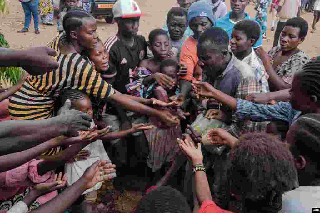 Congolese refugees, displaced by ongoing clashes in eastern Democratic Republic of Congo, gather to receive soft drinks from a social worker at the Gihanga refugee transit camp in Gihanga, Burundi, Feb. 17, 2025.