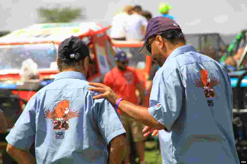 Rhino Charge competitors chat during scrutineering (or inspection of competing cars) in Narok county, Kenya, May 29, 2016. The annual event is "a big, big thing for these guys, and there's many, many a night spent in bars around Kenya, guys talking about where they went wrong and the guy who won saying how he was so good," said one of more than 200 unpaid volunteers for the Rhino Charge. (J. Craig/VOA)