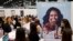 FILE - A poster for former first lady Michelle Obama's memoir, "Becoming," is displayed at the Penguin Random House exhibit, May 31, 2018, at Book Expo in New York. The book went on sale this month.