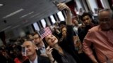 A new U.S. citizen takes a selfie with her mobile phone after taking the Oath of Allegiance during a special naturalization ceremony at the U.S. Citizenship and Immigration Services District Office in the Manhattan borough of New York City.