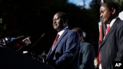 Kenya's opposition leader Raila Odinga, accompanied by party official Kalonzo Musyoka, right, announces they will challenge the results of last week's presidential election in the Supreme Court.