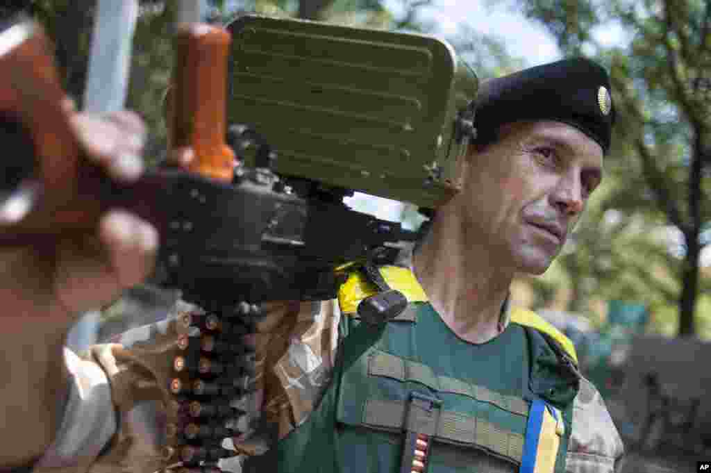 A Ukrainian government soldier from the &quot;Donbass&quot; battalion guards a position in the village of Mariinka, near Donetsk, eastern Ukraine, Aug. 12, 2014.