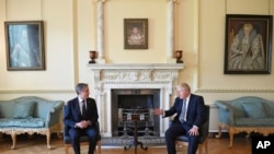 Britain's Prime Minister Boris Johnson, right, and U.S. Secretary of State Antony Blinken meet inside 10 Downing Street in London, May 4, 2021.