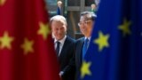 FILE - European Council President Donald Tusk and Chinese Premier Li Keqiang arrive to attend an EU-China Summit in Brussels, Belgium, June 2, 2017.