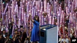 First Lady Michelle Obama waves as she speaks to delegates during the first day of the Democratic National Convention in Philadelphia , Monday, July 25, 2016. (AP Photo/Matt Rourke)