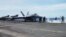 An F18 fighter prepares to take off at the flight deck of the USS Theodore Roosevelt while transiting the South China Sea, April 10, 2018. 