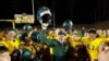 Paradise High School head football coach Rick Prinz, center, celebrates with his team after defeating Live Oak High School, 56-0, in their Northern California Division III playoff game in Paradise, Calif., Nov. 15, 2019. 