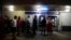 Clients of Popular Bank of Puerto Rico wait in line at the Carolina Shopping Court branch to withdraw cash from their accounts after the passage of Hurricane Maria, in Carolina, Puerto Rico, Sept. 27, 2017.