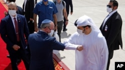 Israeli National Security Advisor Meir Ben-Shabbat, center left, elbow bumps with an Emirati official as he leaves Abu Dhabi, Arab Emirates, Sept. 1, 2020.