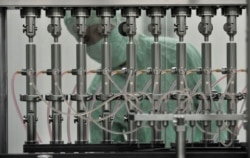 FILE - A worker is seen at the manufacturing workshop of vaccine maker Wuhan Institute of Biological Products in Wuhan, Hubei province, China, May 26, 2010.