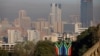 FILE - A general view of Pretoria's skyline with South African flags displayed on a lamp post are seen in Pretoria, South Africa, June 19, 2024.