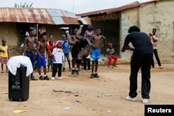 Joshua Anum, who had his left arm amputated 7 years ago, reacts during a rehearsal with other members of "The Incredible Kids" dance group, in Abuja, April 30, 2022. (REUTERS/Afolabi Sotunde)