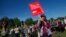 A demonstrator holds a placard calling on the G8 to take on global hunger at a rally in Hyde Park, central London, June 8, 2013. 