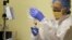 FILE - A nurse practitioner prepares to start the first human gene editing treatment for Hunter syndrome, an inherited metabolic disease, at a hospital in Oakland, Calif., Nov. 13, 2017. On Aug. 15, 2018, federal officials said that gene therapy is becoming an established form of medical care and carries no special risks that warrant special regulation, as they revised rules for vetting such experiments and products.