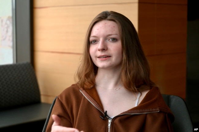 Shae Ross, a senior at Jefferson High School, pose for a photo April, 19, 2024, in Bloomington, Minn. Ross and other students successfully campaigned their district not to ban certain books dealing with sexuality, gender and race. (AP Photo/Mark Vancleave)