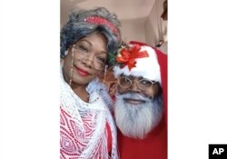 This photo shows Eric Elliott and his wife, Moeisha Elliott, at home in Killeen, Texas, on Oct. 29, 2022. The Elliotts have invested in months of professional training to play Santa and Mrs. Claus but said some prospective clients aren’t looking for Black performers. (Eric Rex Elliott via AP)