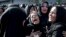FILE - In this file photo dated, Sept. 24, 2018, families of victims of a terror attack on a military parade in the southwestern city of Ahvaz, Iran, that killed 25 people mourn at a mass funeral in Ahvaz.