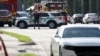 A police officer gestures as agents investigate reports of shots fired outside Republican presidential nominee and former U.S. President Donald Trump's Trump International Golf Course in West Palm Beach, Florida, Sept. 15, 2024. 