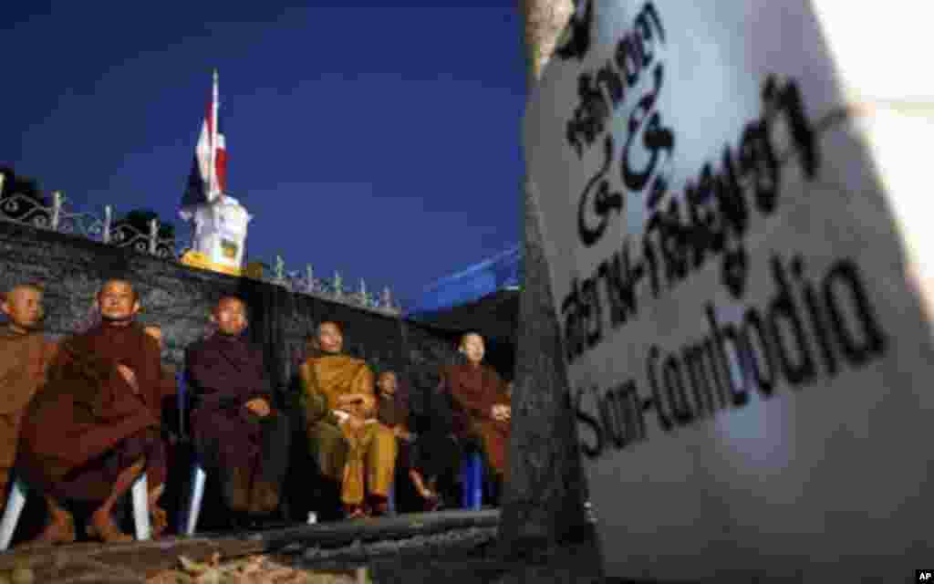 Buddhist monks join supporters of the yellow-shirted People's Alliance for Democracy as they listen to a speech from the stage during a rally near Government House in Bangkok January 28, 2011. Thai "yellow shirt" demonstrators returned to Bangkok's street