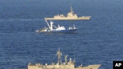 In this photo released by the Spanish defense ministry the Spanish trawler Alakrana is seen at center, escorted by two Spanish frigates in a photo taken off Somalia's coast, November 17, 2009