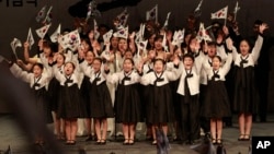 Elementary school students wave South Korean national flags during a ceremony to celebrate the March First Independence Movement Day.