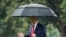 President Donald Trump walks in the rain on the South Lawn of the White House in Washington, June 11, 2020, before boarding Marine One for a short trip to Andrews Air Force Base, Md., and then on to Dallas. 