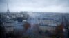 Para pengunjuk rasa mengenakan rompi kuning, simbol protes para pengendara Perancis terhadap kenaikan pajak solar, berdemonstrasi di Place de l'Etoile, Paris dengan latar belakang menara Eiffel, Perancis, 1 Desember 2018. (Foto: dok).