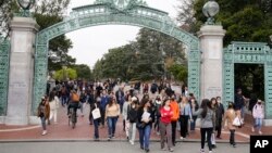 File - Students make their way through the Sather Gate near Sproul Plaza on the University of California, Berkeley, campus March 29, 2022, in Berkeley, Calif.