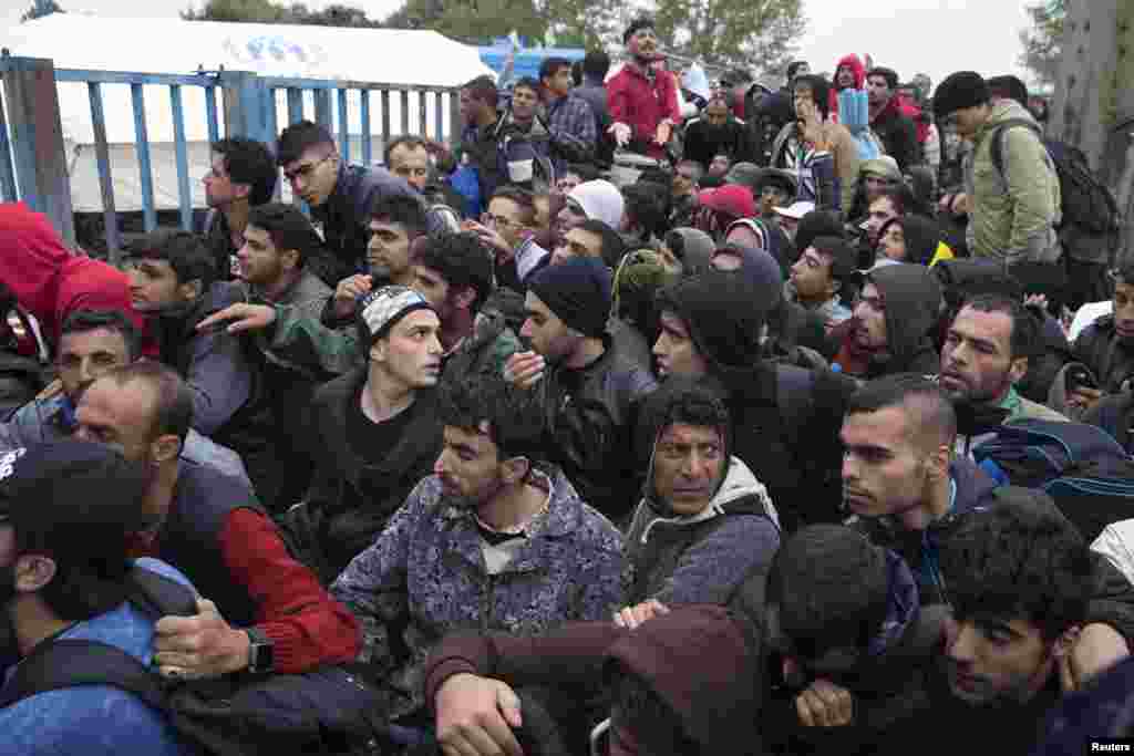 Migrants wait in front of a registration camp for migrants in Opatovac, Croatia. Interior Minister Ranko Ostojic said Croatia will demand that Greece stop moving migrants from the Middle East on to the rest of Europe. Around 29,000 people, mostly from Syria, have arrived in Croatia from Serbia in the past week after trekking northwards through the Balkans from Greece.