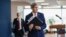 U.S. Secretary of State John Kerry picks up his notebook after answering questions from members of the media before his departure from Ben Gurion International Airport in Tel Aviv on Friday, Dec. 6, 2013.