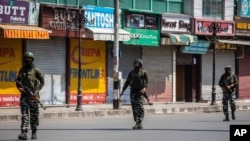 Indian paramilitary soldiers patrol a deserted market area in Srinagar, Indian controlled Kashmir, Sept. 2, 2021 as Indian authorities cracked down on public movement after the death of Syed Ali Geelani, a top separatist leader.