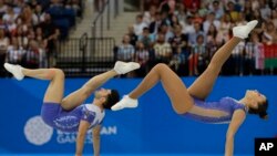 FILE: Michela Castoldi and Davide Donati, of Italy, compete on the way to winning a gold medal in the mixed pairs final of the Aerobic Gymnastics during the Second European Games in Minsk, Belarus, on Mon. June 24, 2019. 